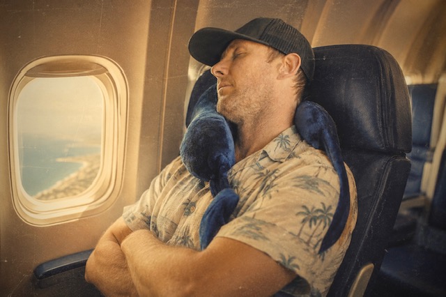 Resting against an airplane window at golden hour